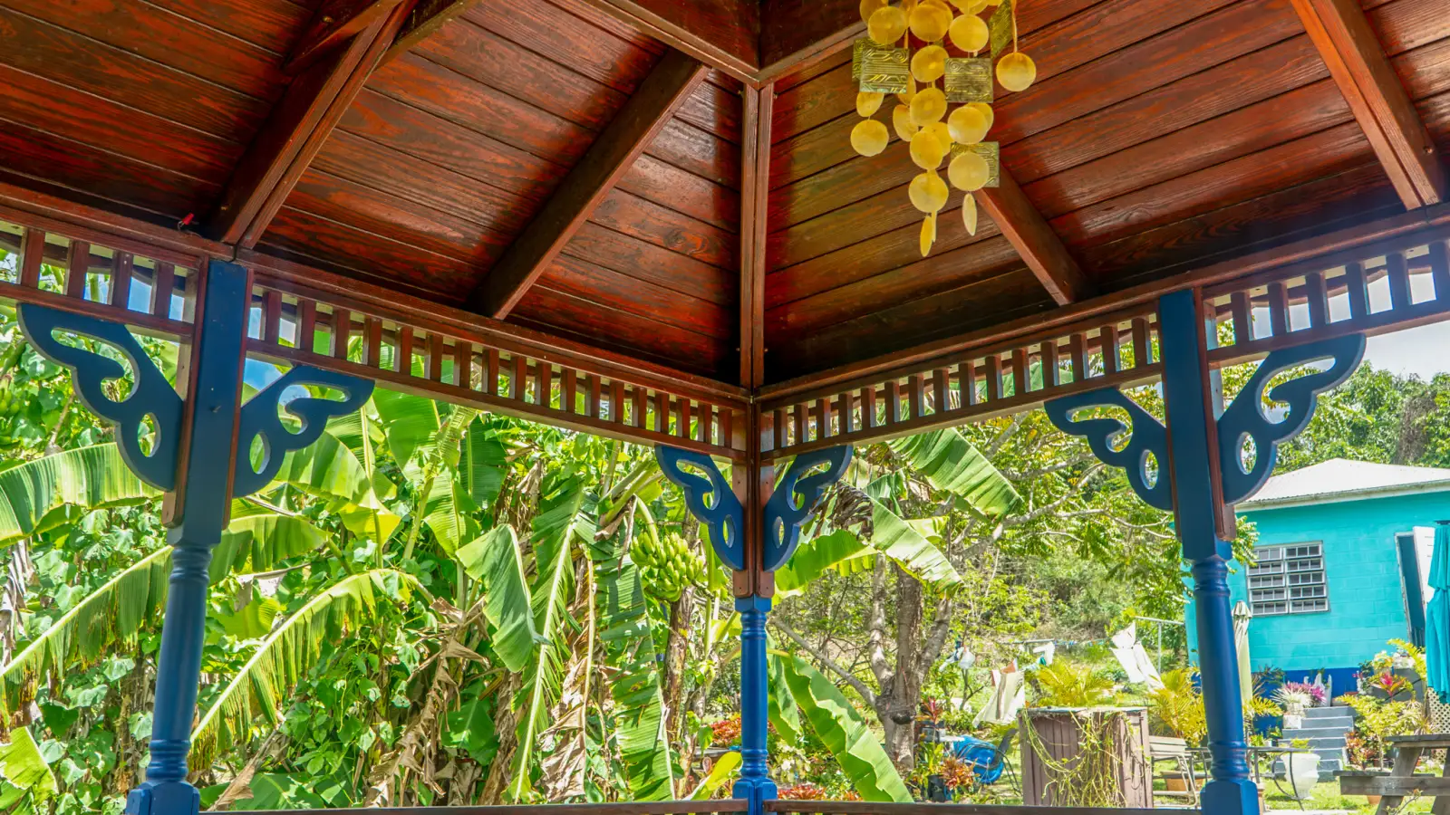 Shaded wooden gazebo in the fruit garden at LambLion Apartments in central Antigua