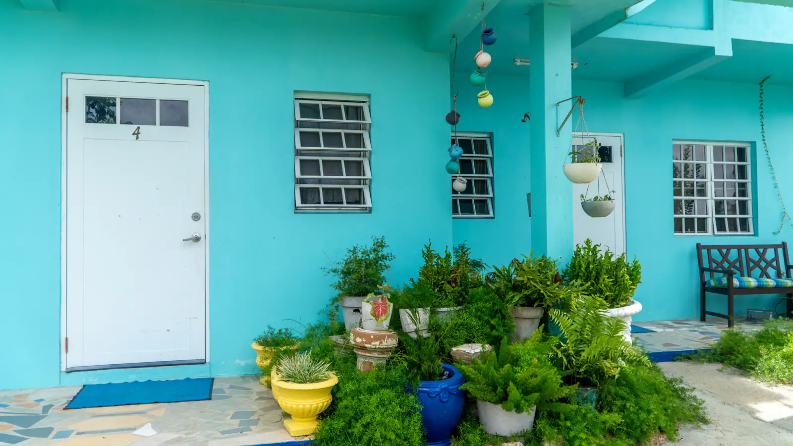 Apartment entrance with potted plants at LambLion in central Antigua