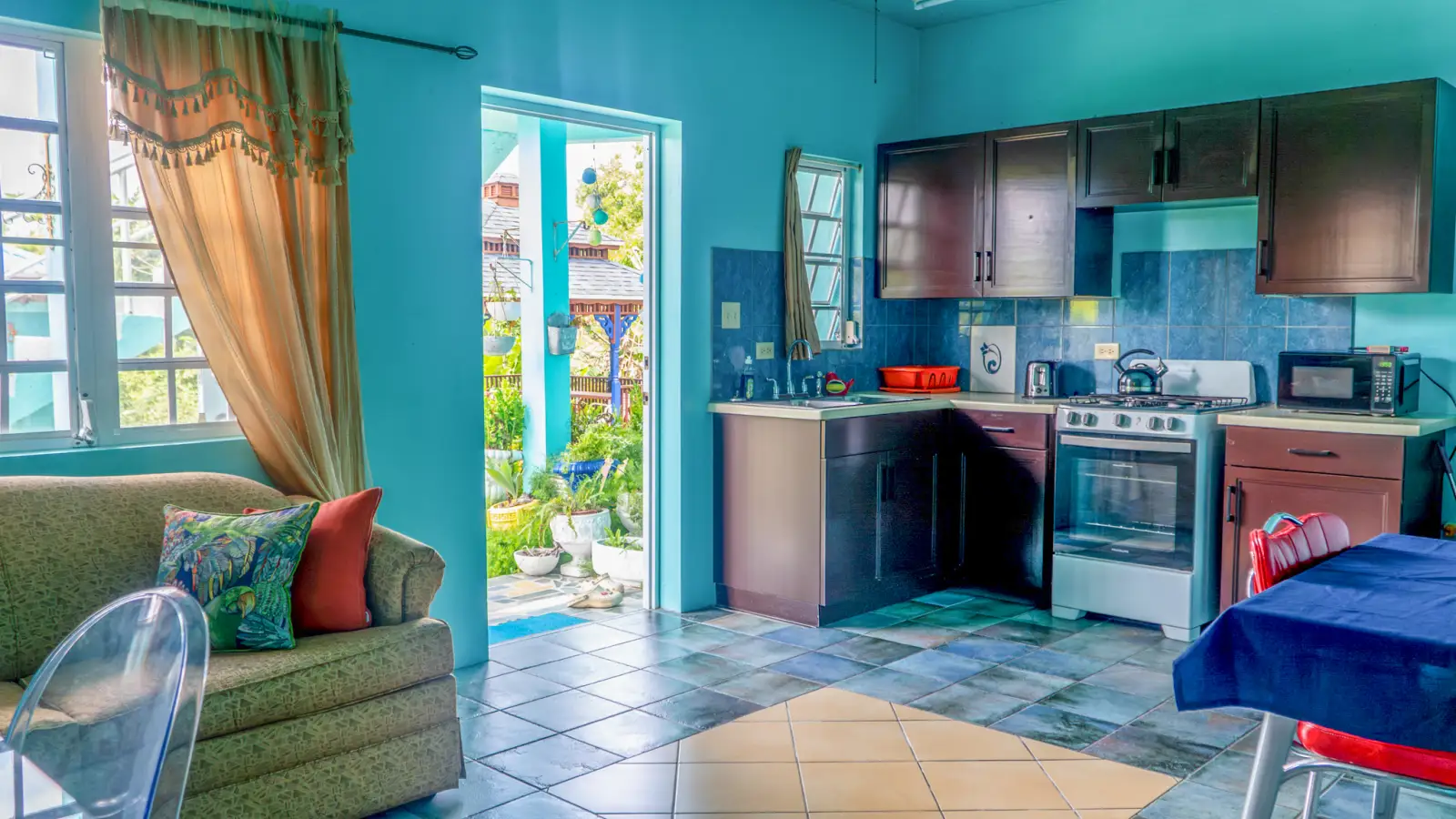 Living room and open kitchen in a one bedroom self catering apartment at LambLion, Antigua