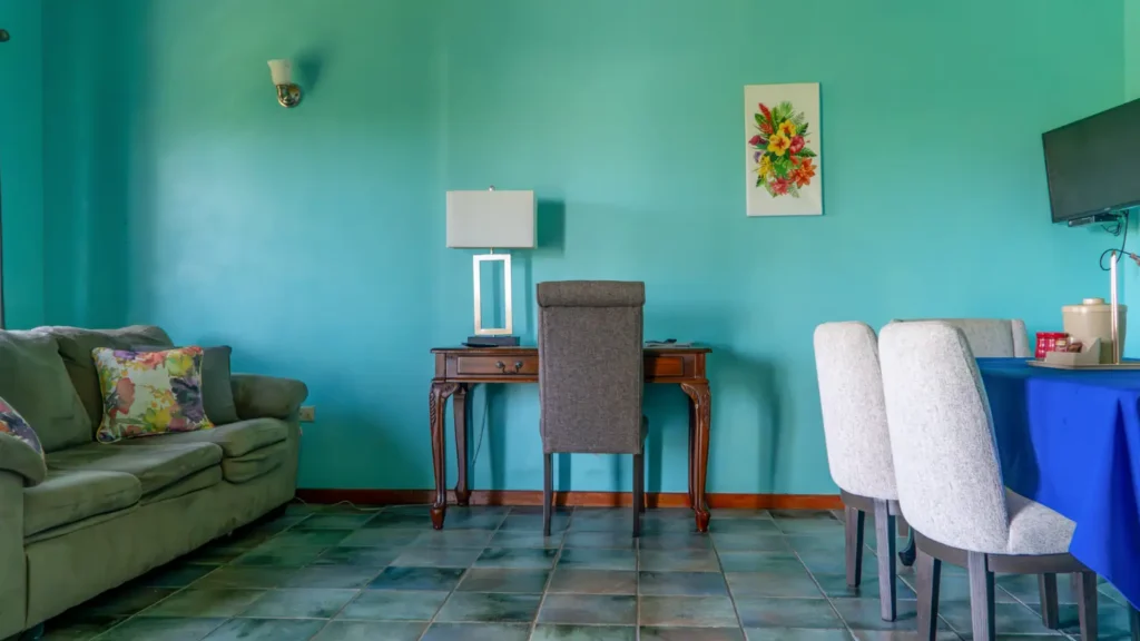 Living room with a desk and sofa in a LambLion apartment, a work setup for remote workers in Antigua