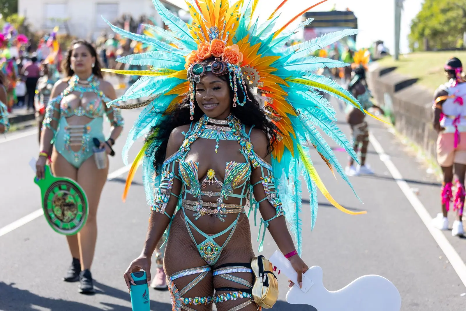 Masquerader in a feathered costume on the road at a Caribbean carnival in Saint Kitts, Antigua's Leeward Islands neighbour