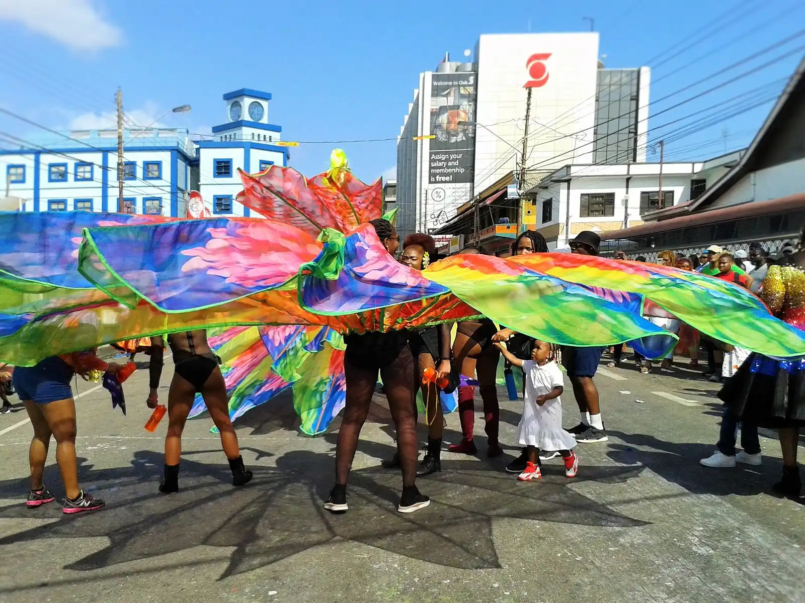 Carnival masqueraders with huge painted wings parading through Port of Spain, Trinidad