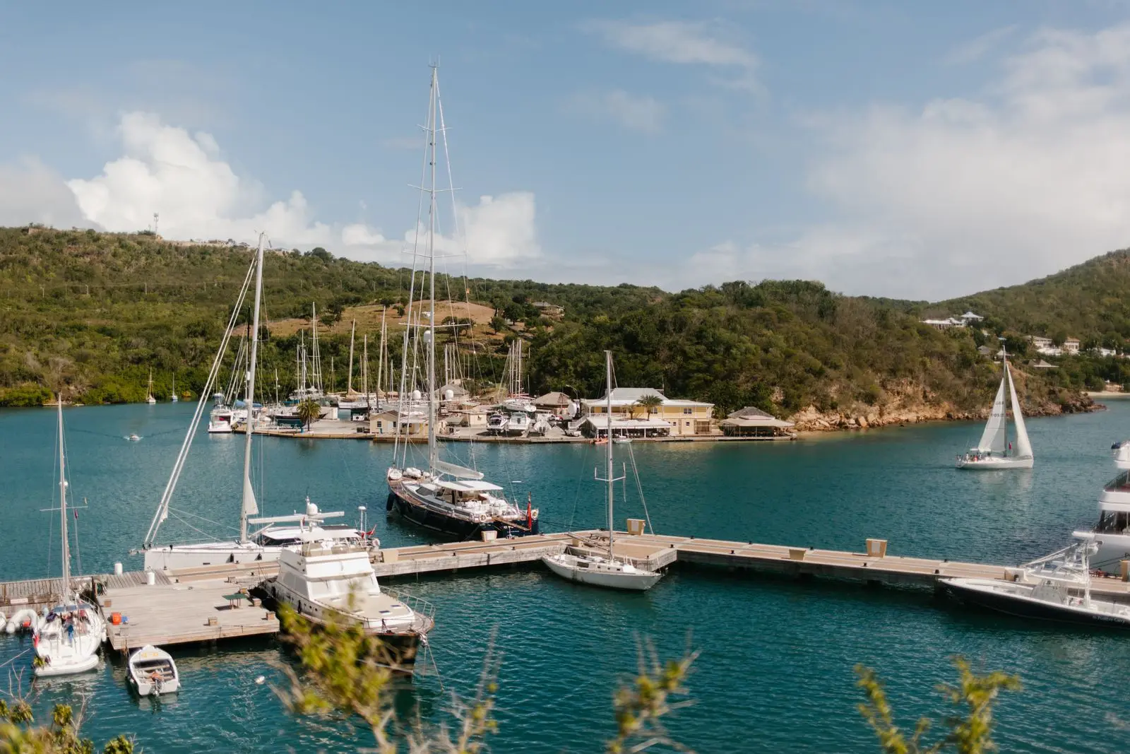 Sailing yachts and motor yachts tied up on the docks of a Caribbean marina