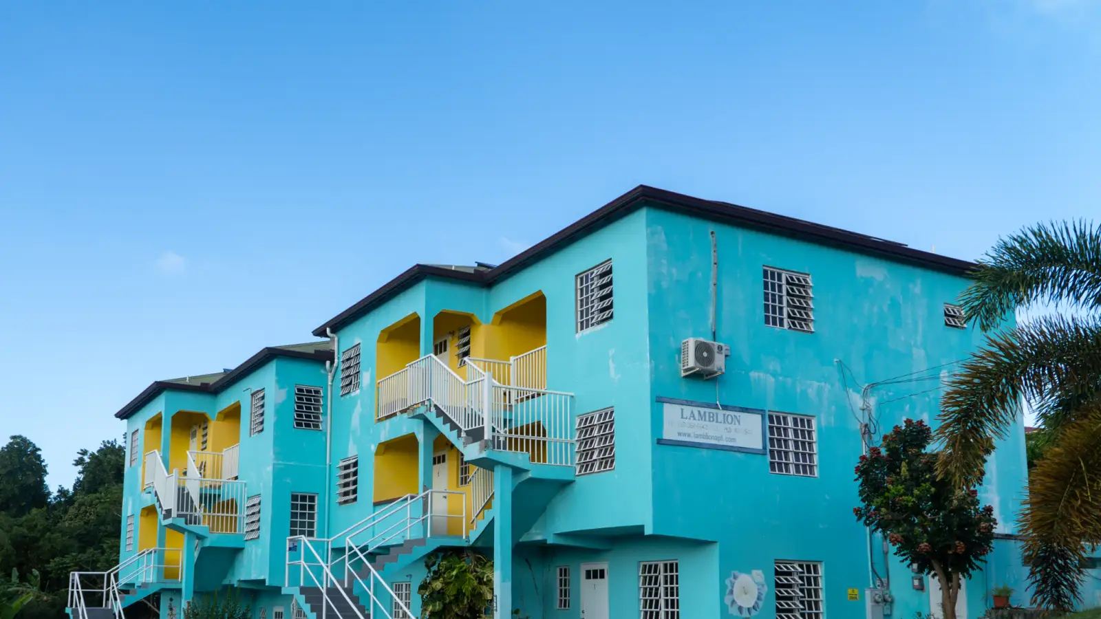 LambLion Apartments building under a blue sky in central Antigua