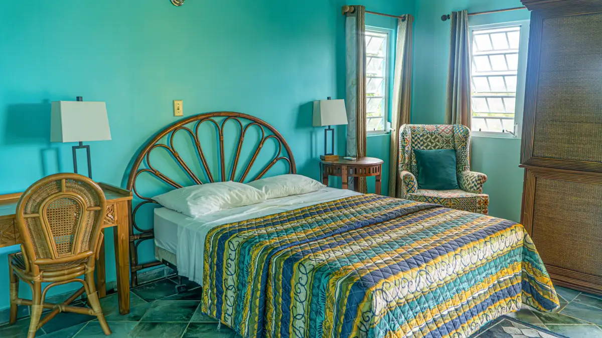 Air-conditioned bedroom with a desk at LambLion Apartments, central Antigua
