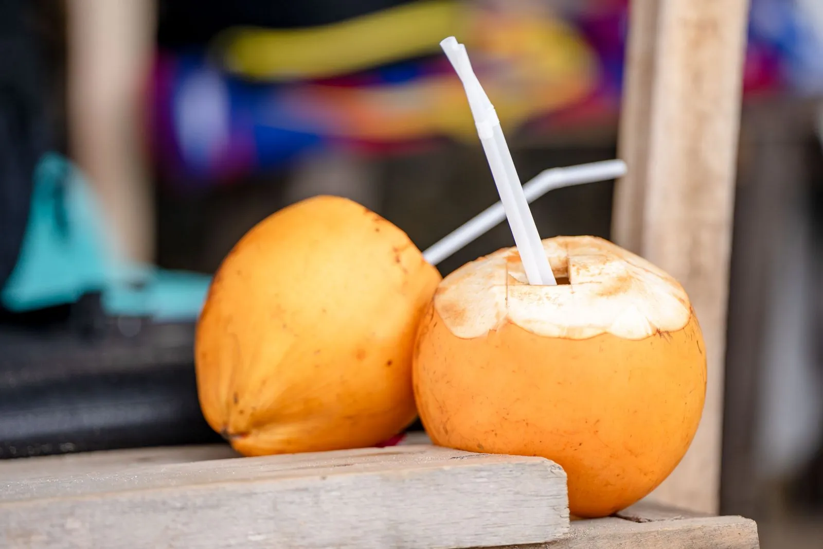 Two fresh coconuts with straws for drinking coconut water